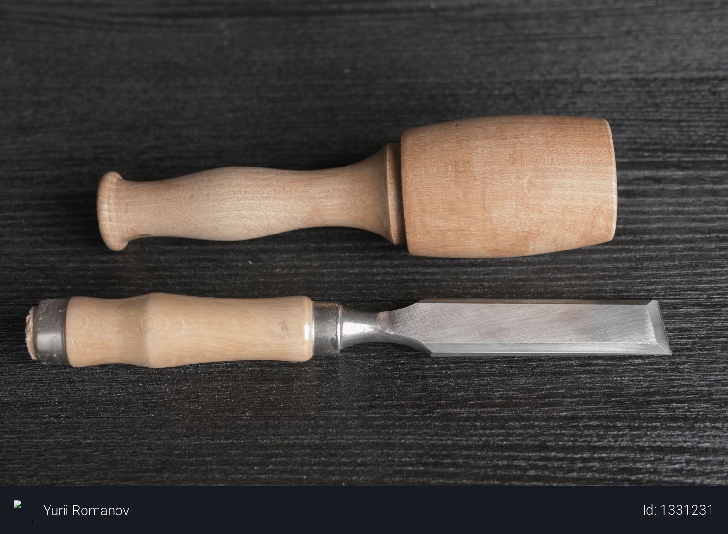 Chisel and wooden mallet on a black background. joiner's workshop Photo