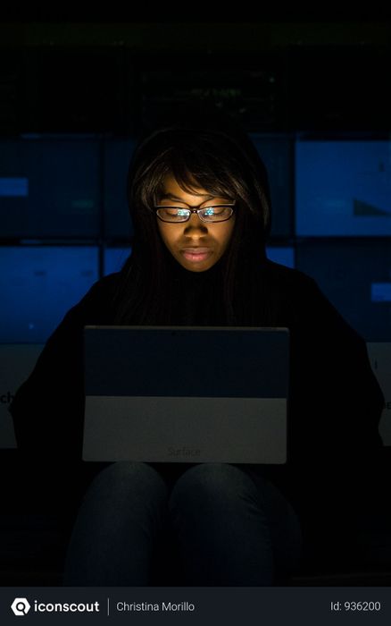 Woman Wearing Eyeglasses Looking At Tablet Computer In Dark Room Photo