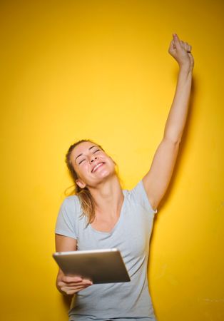 A Happy Woman Holding An Ipad Photo