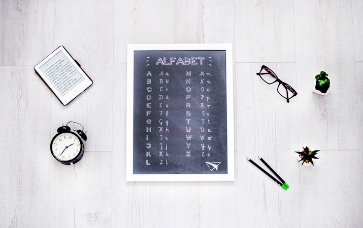 Alphabet Chalkboard At The Center Of Assorted Items Photo