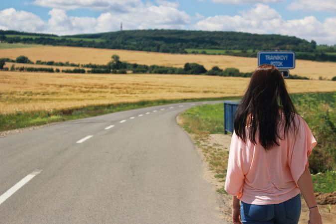 Back View Of Woman Wearing Pink T-shirt On Road Against Sky Photo