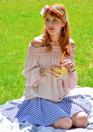 Beautiful Woman Sitting In Garden Photo