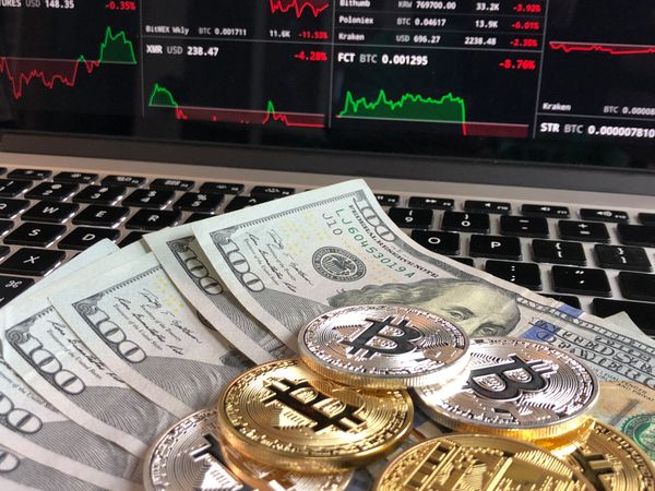 Bitcoins And Cash On Laptop Photo