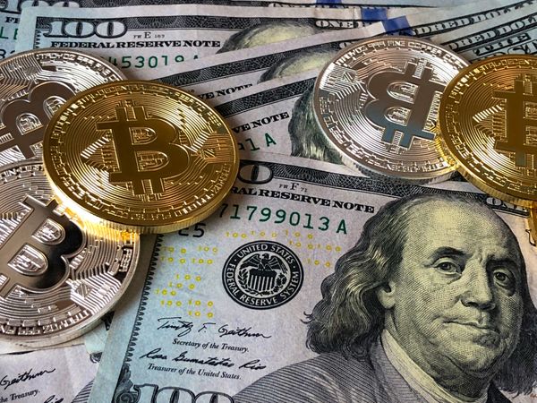 Bitcoins And U.s Dollar Bills Photo