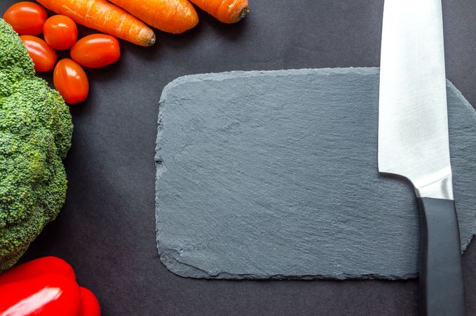 Black Handle Knife Near The Carrots Photo