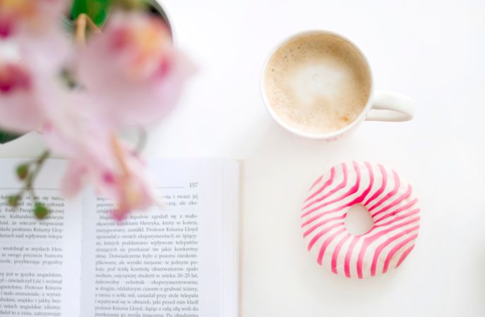 Book, Doughnut And Coffee Cup On White Table Photo