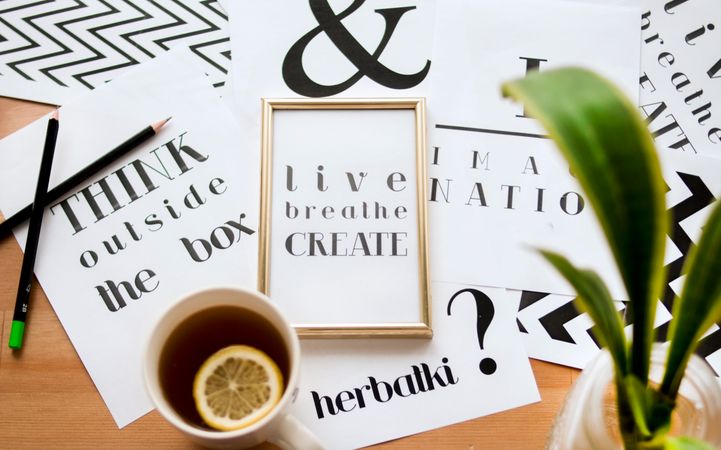 Book Titles And Black Lemon Tea On Wooden Table Photo