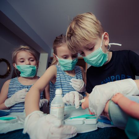 Boy Cleaning Dolls Legs Photo