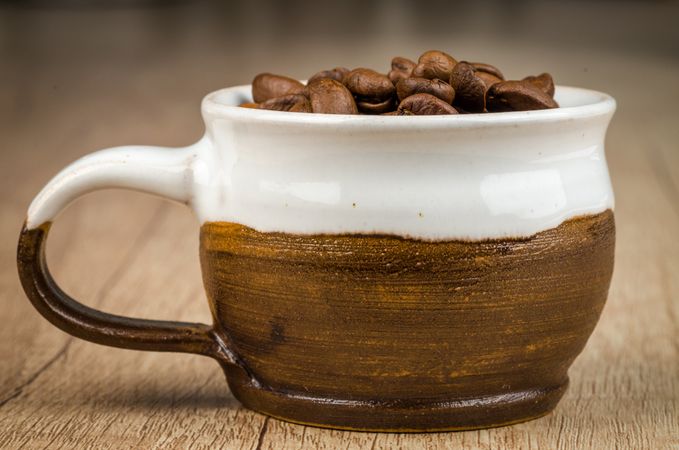 Brown And White Cup Full Of Coffee Beans Photo