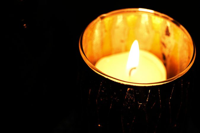 Burning Candle In Dark Photo