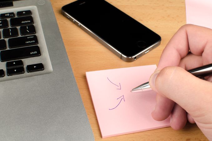 Businessman Draw Arrows On Sticky Notes On Desk Photo