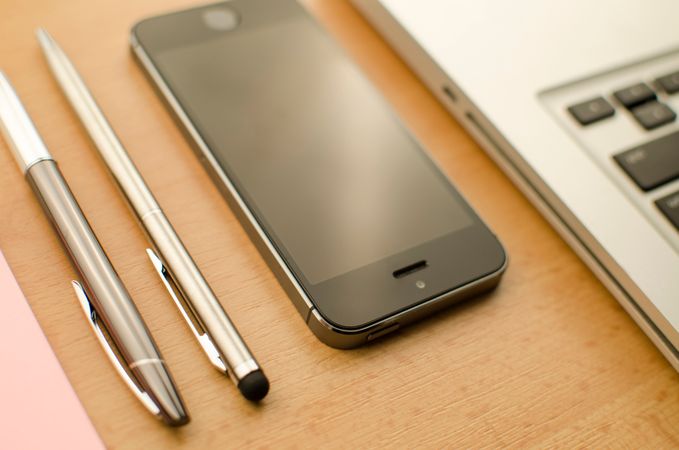 Cellphone Beside Pen On Desk Photo