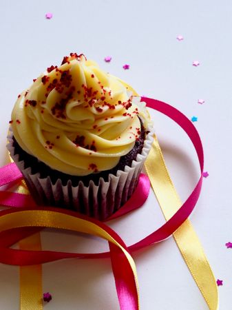 Chocolate Cupcake With White And Red Toppings Photo