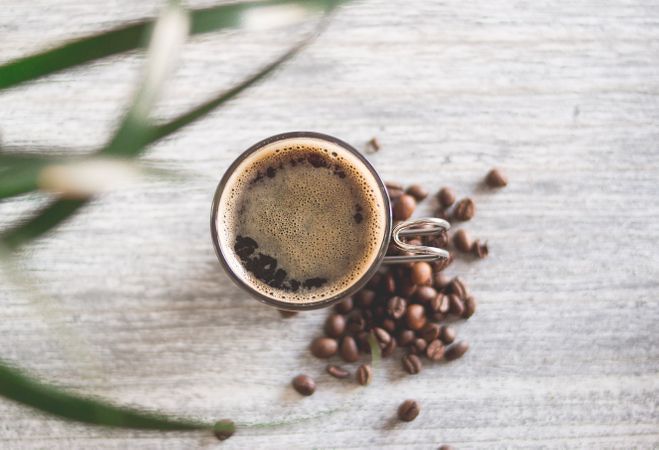 Clear Glass Cup Filled With Coffee Near Coffee Seed Photo