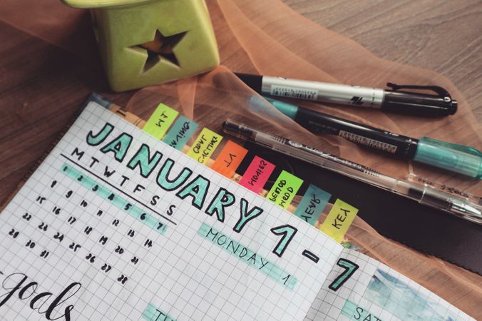 Closeup Shot Of Daily Planner Diary With Colorful Marker Pens Photo