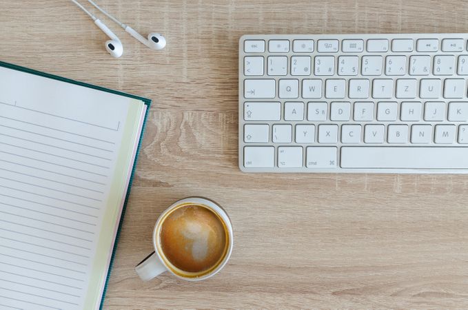 Coffee Cup,Earphone,Book And White Keyboard On Office Desk Photo