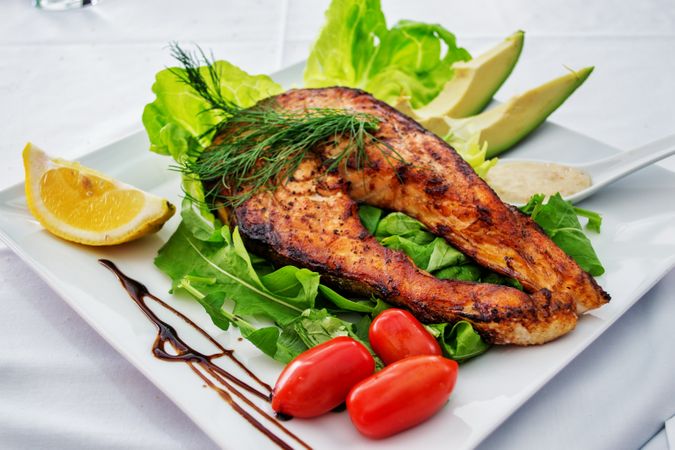 Cooked Meat With Avocado And Tomatoes On White Ceramic Plate Photo