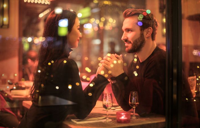 Couple Holding Hands In Cafe Photo