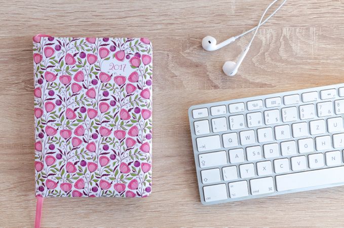 Directly Above Shot Of Laptop Keyboard With Pink Dairy Photo