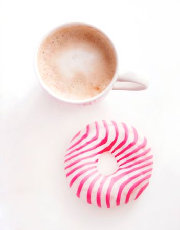 Doughnut And Coffee Cup On White Table Photo