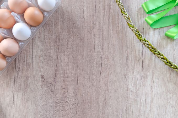 Egg Tray, Chain And Green Ribbon On Wooden Table Photo