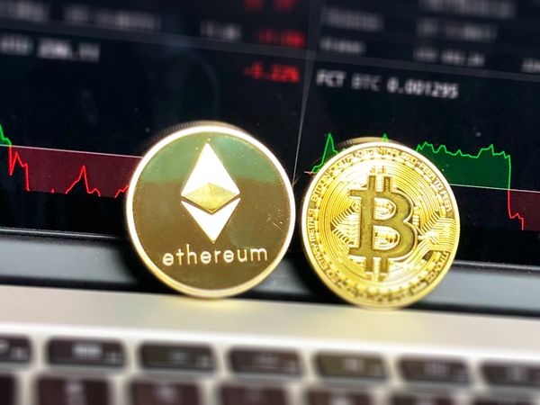 Ethereum Beside Bitcoin On Laptop Photo