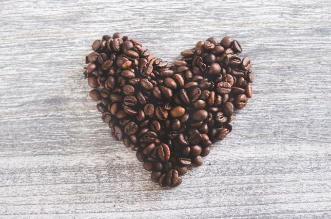 Flatlay Photo Of Heart Shaped Coffee Beans On Wooden Table Photo