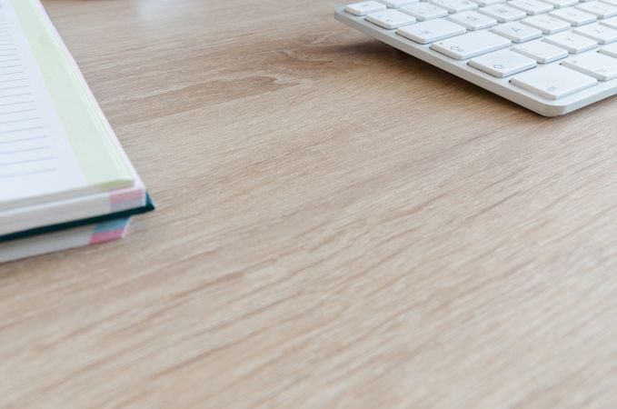 Focused Half Book And White Keyboard On Desk Photo