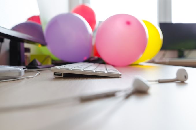 Focused Keyboard And Balloons On Desk Photo
