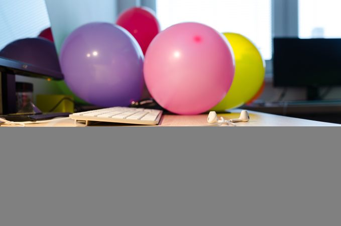 Focused Keyboard And Balloons On Desk Photo