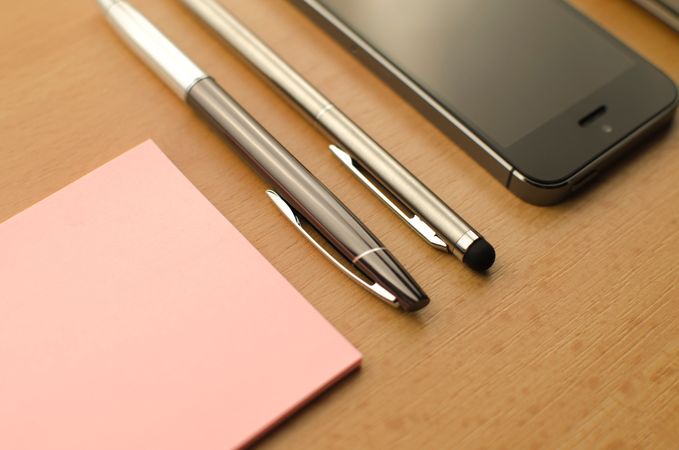Fountain Pen And Pink Sticky Notes On Brown Wooden Table Photo