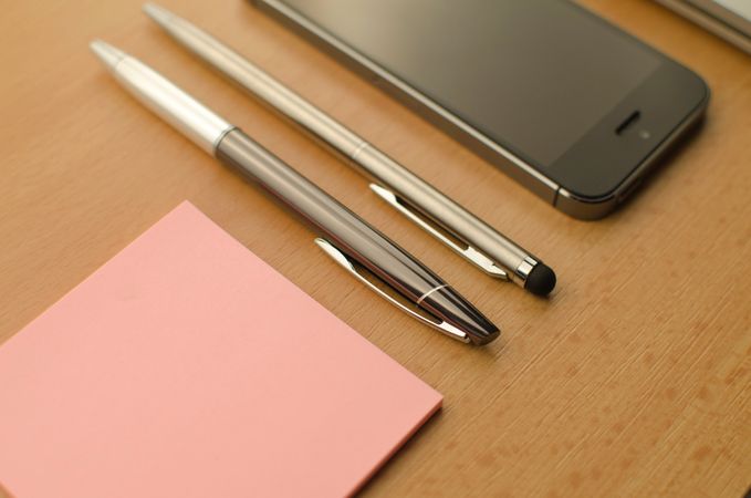 Fountain Pen And Pink Sticky Notes On Brown Wooden Table Photo