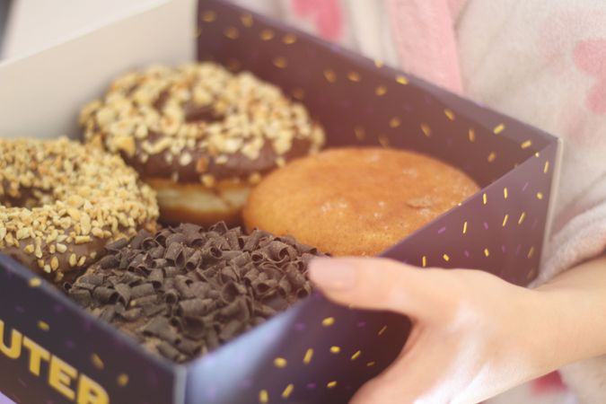 Four Baked Donuts In Box Photo
