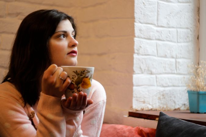 Girl Having Cup Of Coffee During Morning On Sofa Photo