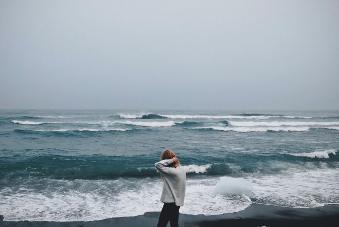 Girl In Whit T-shirt And Black Jeans Walking On Beach Photo