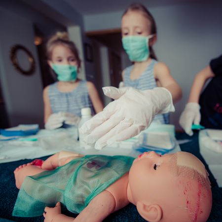 Girl Pointing Something While Plying Doctor-Doctor Photo