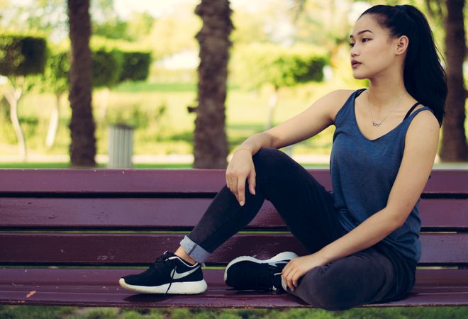 Girl Sitting On Park Bench During Morning Exercise Photo