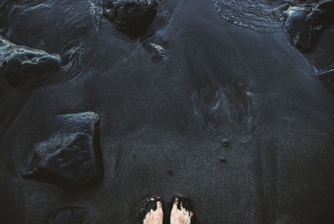 Girl Standing On Black Sand Photo