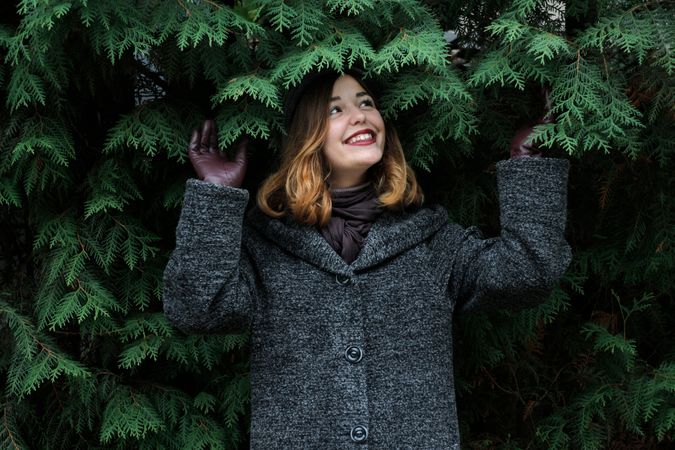 Girl Standing Under Green Leaves While Smiling Photo