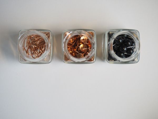 Glass Jar With Black Pins And Metals Photo