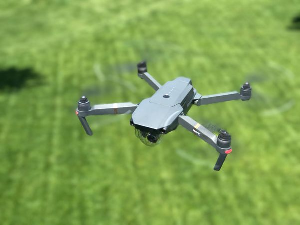 Grey Drone Flying In Garden Photo