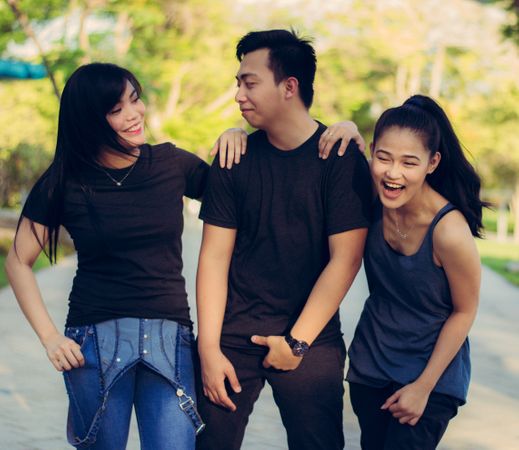 Group Of Friends Smiling While Walking In Garden Photo
