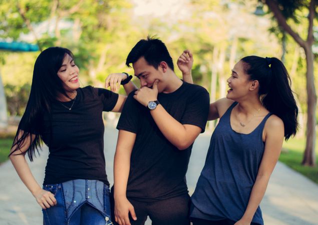Group Of Friends Smiling While Walking In Garden Photo