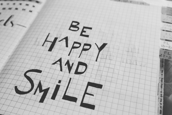 Happy Energetic Quote On Graph Paper Photo