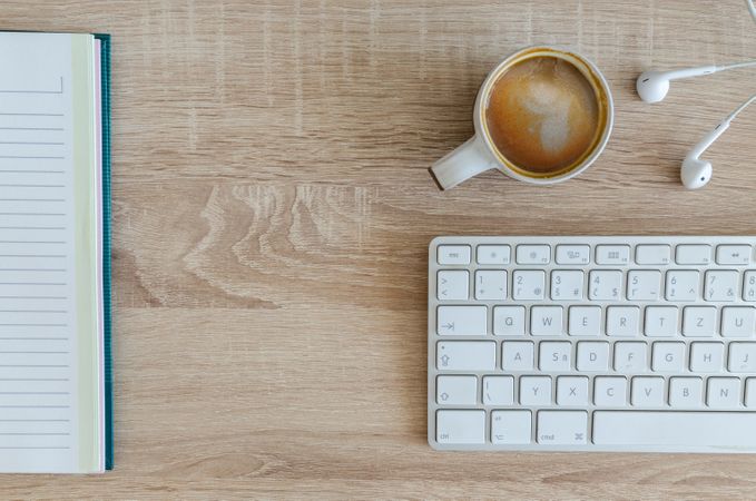 High Angle View Of Coffee Cup On Table With White Key Board Photo