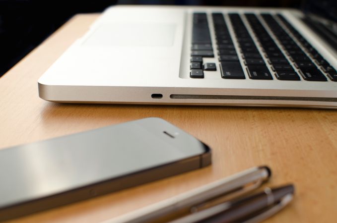Keyboard And Iphone On Wooden Desk Photo