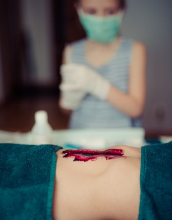 Kids Playing Surgeon With Doll In Room Photo
