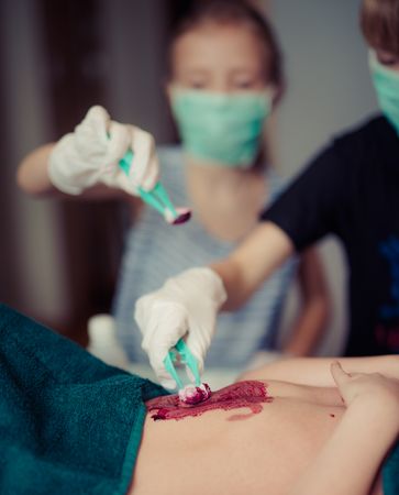 Kids Trying To Clean Blood Of Baby While Playing Photo