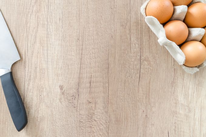 Knife And Eggs On Wooden Board Photo