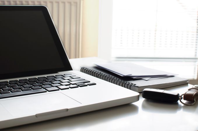 Laptop And Car Keys On Table At Office Photo